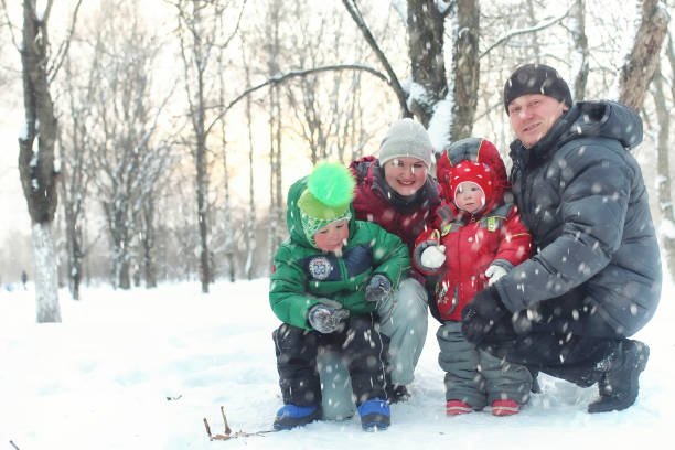 istock Young family in winter park 1149513360
