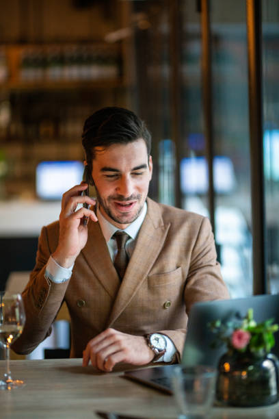istock Cheerful businessman making a phone call from restaurant 1149517939