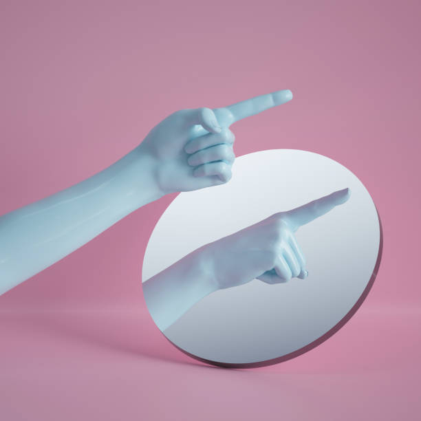 istock 3d render, hand reflection in round mirror isolated on pink background, abstract conceptual composition, pointing finger, show gesture, mannequin body part 1149518396