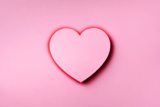 istock Pink heart cutted from paper over punchy pastel background with copy space. Top view. Valentine's Day. Love, date, romantic concept. 1149520643