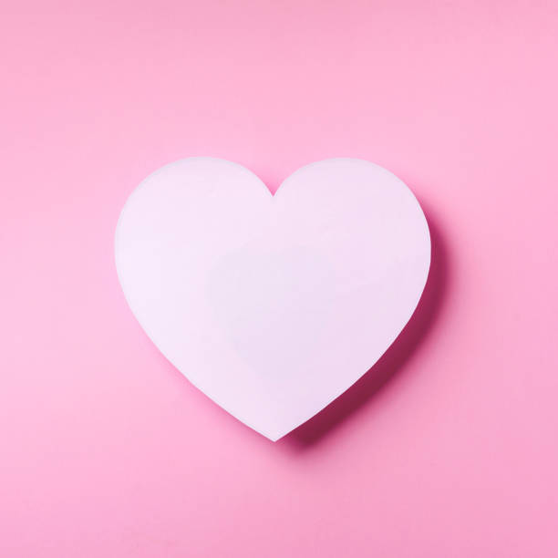 istock White heart cutted from paper over punchy pastel background with copy space. Top view. Valentine's Day. Love, date, romantic concept. Square crop. 1149520998