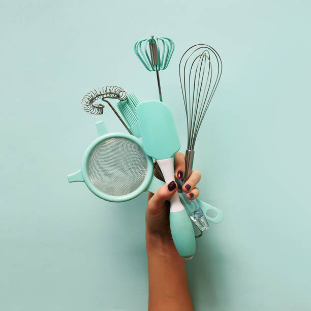 istock Baking flat lay. Female hands holding kitchen tools, sieve, rolling pin, spatula and bruch on pastel blue background. Banner with copy space. Top view 1149522769