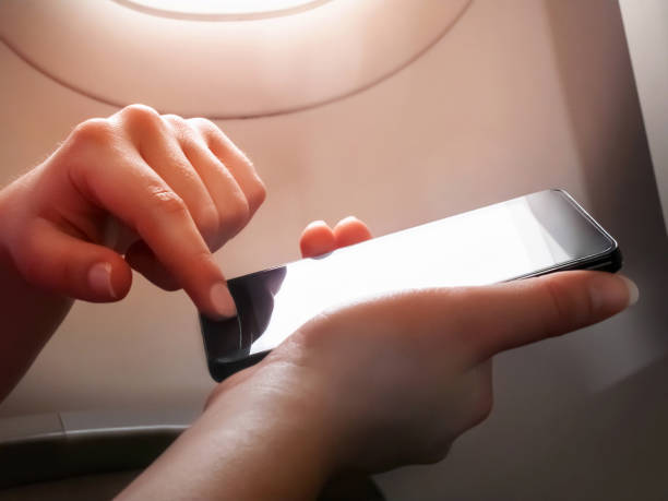 istock Woman hand using smart phone on the airplane 1149522919