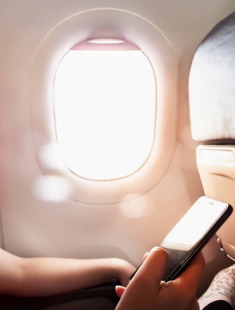 istock Woman hand using smart phone on the airplane 1149522922