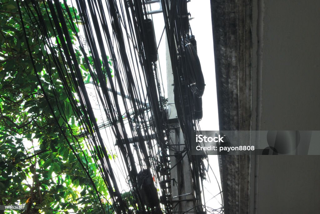 Power cord on the power pole Power lines and cables that are cluttered on electric poles May cause a danger of electric shock Architectural Column Stock Photo