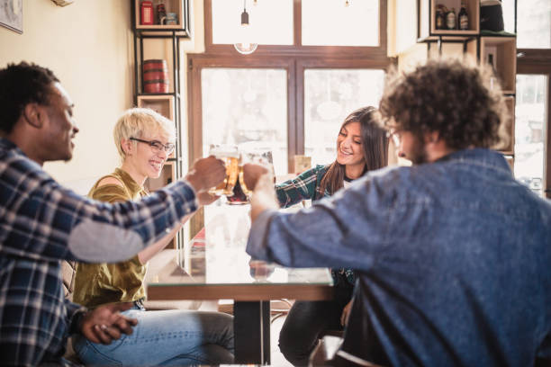 istock Group of young, multi racial people having fun in a local pub 1149526555