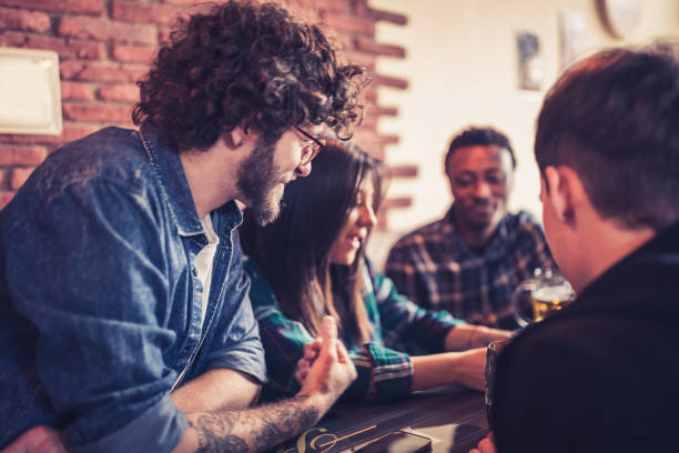 istock Group of young, multi racial people having fun in a local pub 1149527508
