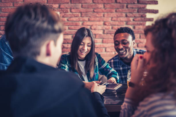 istock Group of young, multi racial people having fun in a local pub 1149527523