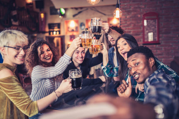 istock Group of young, multi racial people having fun in a local pub 1149527604