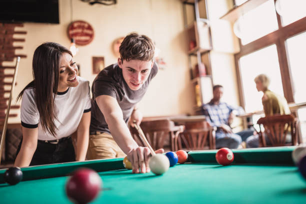 istock Young couple playing pool in local pub 1149528143