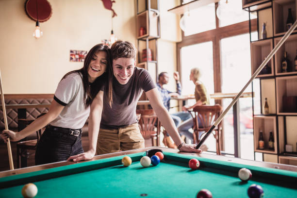 istock Young couple playing pool in local pub 1149528226