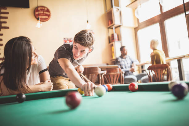 istock Young couple playing pool in local pub 1149528287