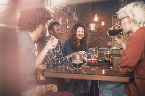 istock Group of young, multi racial people having fun in a local pub 1149528464