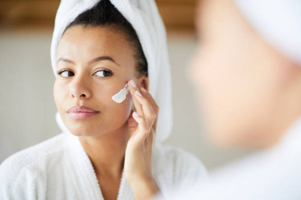 istock Mixed Race Woman Applying Face Cream 1149534468