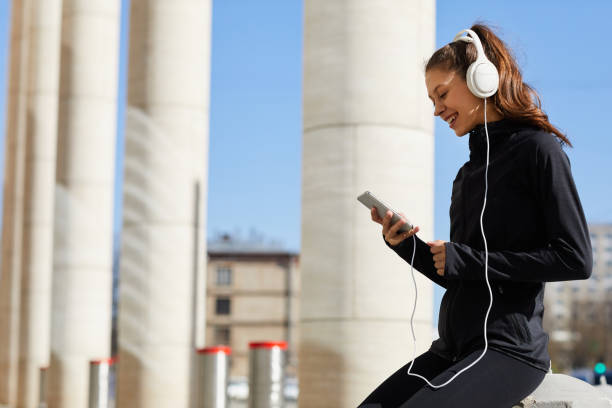 istock Cheerful jogger chatting online during rest 1149534980