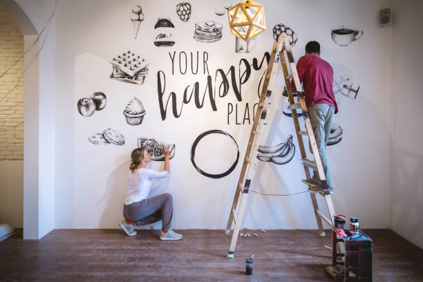 istock Inspirated couple adding paintings to their bland white wall 1149536324