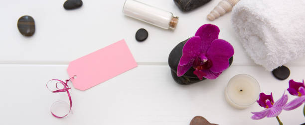 istock Spa or wellness setting with pink orchids ,candle and black stones. 1149538350