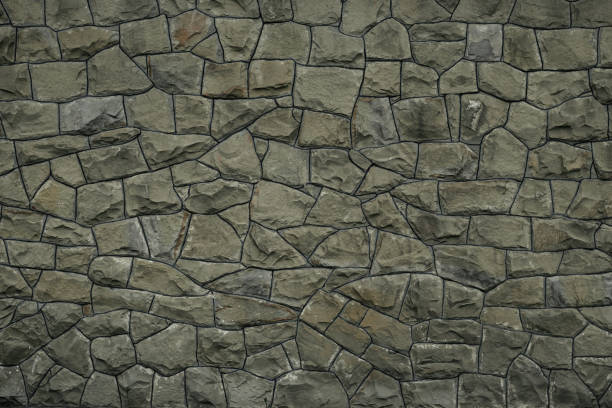 istock Gray green stone wall texture background. Rock texture. Green granite stone surface. Mosaic pattern of grey stones on the cement wall. Old dirty wall rocks texture. Green backdrop of decorative tiles. 1149538876