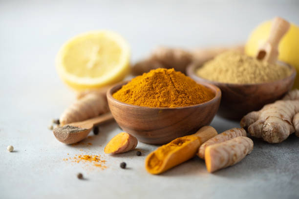 istock Ingredients for hot ayurvedic drink. Turmeric powder, curcuma root, cinnamon, ginger, lemon over grey background. Copy space, square crop. Spices for alternative medicine 1149544813