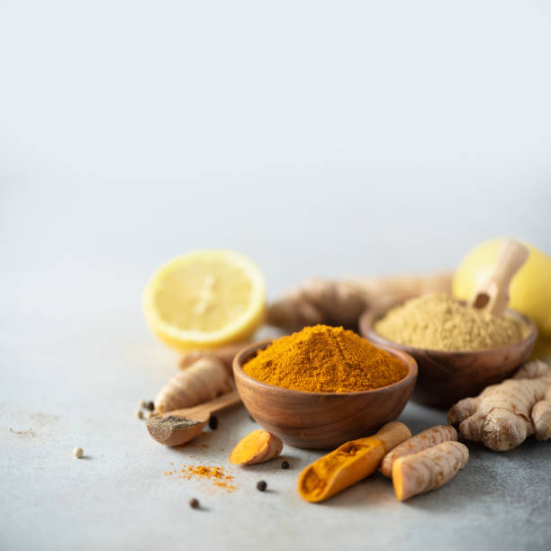 istock Ingredients for turmeric latte. Turmeric powder, curcuma root, cinnamon, ginger over grey background. Copy space, square crop. Spices for ayurvedic treatment. Alternative medicine concept. 1149544816