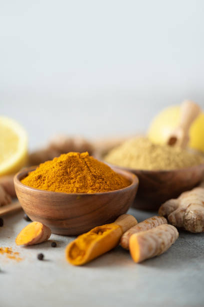 istock Ingredients for hot ayurvedic drink. Turmeric powder, curcuma root, cinnamon, ginger, lemon over grey background. Copy space, square crop. Spices for alternative medicine 1149544829