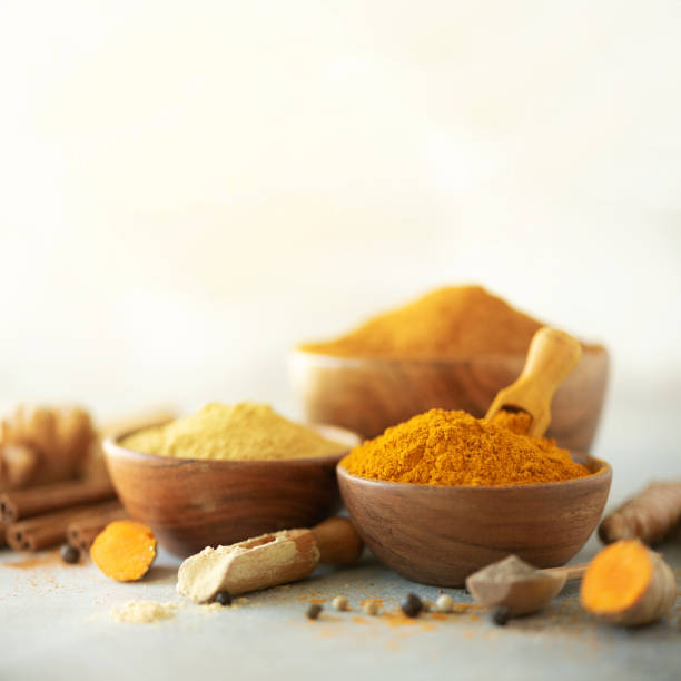 istock Ingredients for hot ayurvedic drink. Turmeric powder, curcuma root, cinnamon, ginger, lemon over grey background. Copy space, square crop. Spices for alternative medicine 1149544859