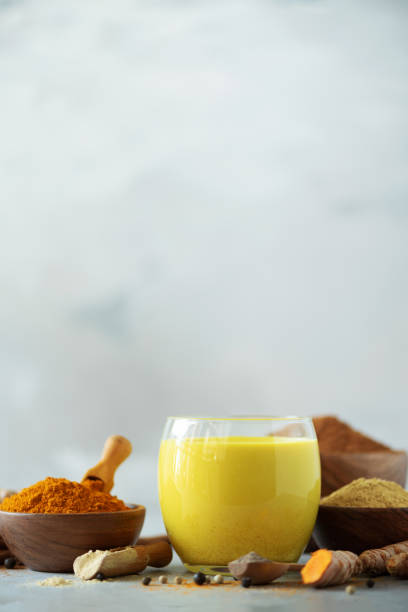 istock Ingredients for turmeric latte. Turmeric powder, curcuma root, cinnamon, ginger over grey background. Copy space, square crop. Spices for ayurvedic treatment. Alternative medicine concept. 1149544867