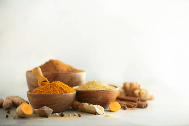 istock Ingredients for hot ayurvedic drink. Turmeric powder, curcuma root, cinnamon, ginger, lemon over grey background. Copy space, square crop. Spices for alternative medicine 1149544868