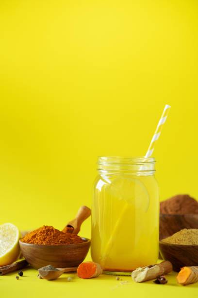 istock Ingredients for orange turmeric drink on yellow background. Lemon water with ginger, curcuma, black pepper. Vegan hot drink concept 1149544944