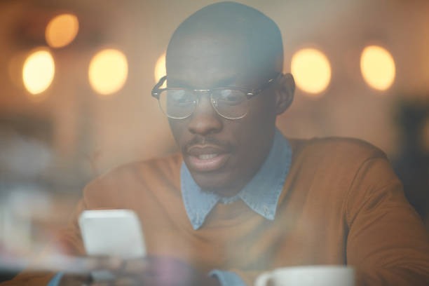 istock African-American Man Using Smartphone in Pub 1149545204