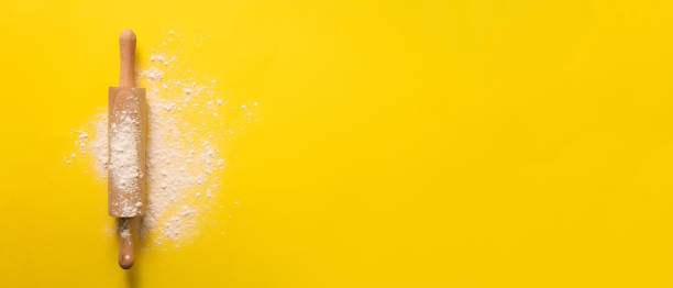 istock Rolling pin with flour on yellow background. Baking, menu, recipe concept. Top view. Banner with copy space for your text 1149547064