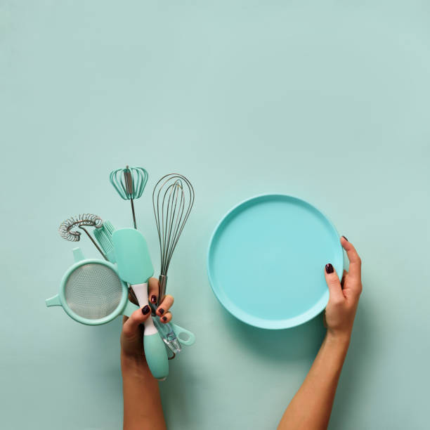 istock Female hand holding empty bowl on blue background with copy space. Healthy eating, dieting concept. Banner. Square crop 1149547249