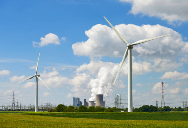 Wind turbines and a coal burning power station.