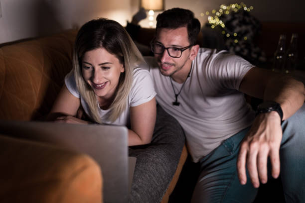 istock Couple watching late night show on lap top and smiling 1149549930