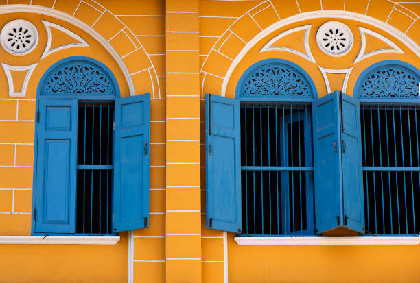 istock Old building with blue window and yellow buildings 1149549977