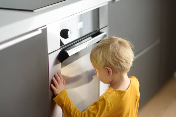 istock Charming boy waiting preparing food in domestic kitchen. 1149552904