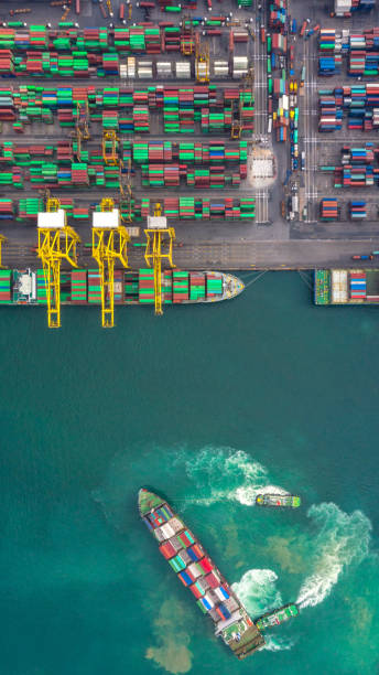 istock Container ship in export and import business logistics and transportation. Cargo and container box shipping to harbor by crane. Water transport International. Aerial view and top view. 1149555287