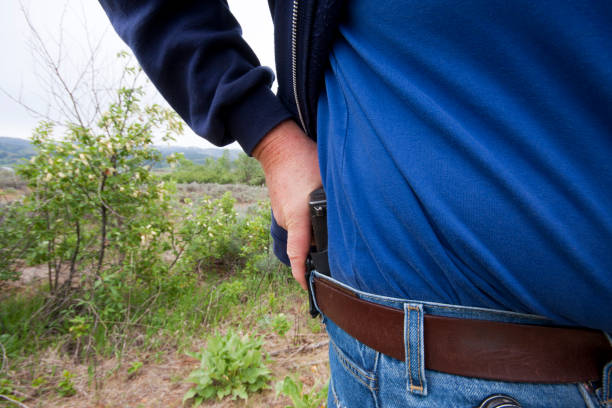 istock Concealed Carry Firearm Drawn From an Inside-the-Waistband Holster 1149555450