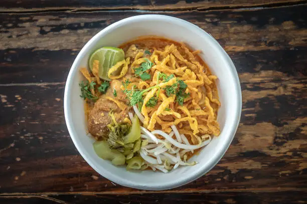 Photo of Curry noodle soup, Khao Soy, a traditional dish in Chiang Mai, Northern Thailand.