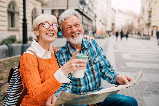 istock Couple holding touristic map and smiling 1149556592
