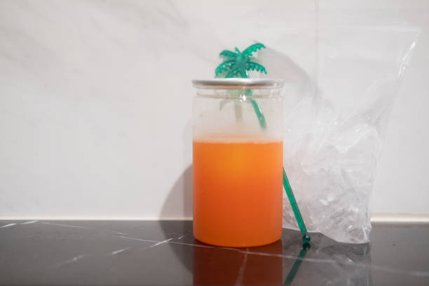 A plastic glass of iced peach soda. Refreshing summer drink concept.