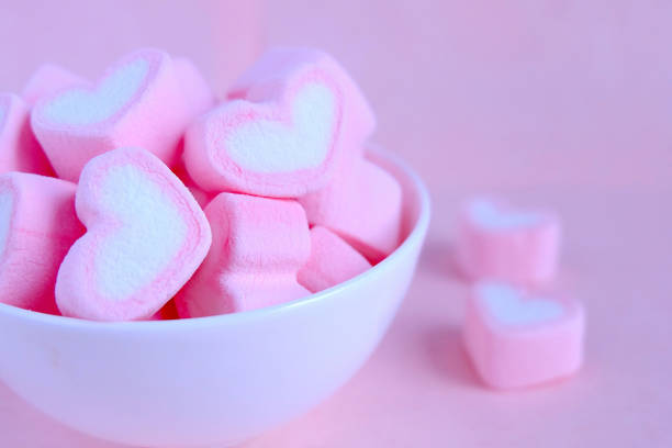 Pink marshmallow background, Heart marshmallow in white cup, Valentine background