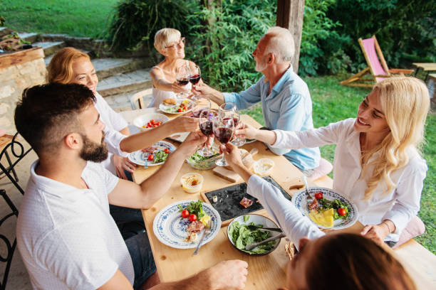istock Family cheering over the dining table outdoors 1149562998