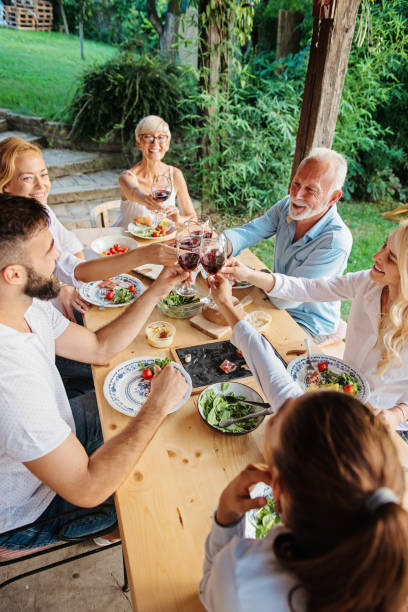 istock Family cheering over the dining table outdoors 1149563156