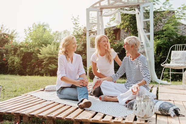 Three women enjoying outdoors, talking and laughing stock photo