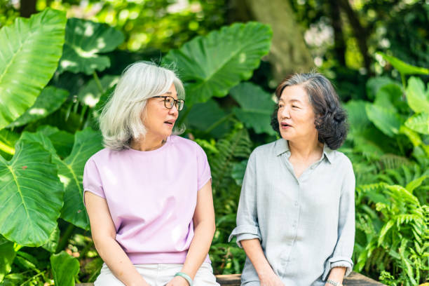 istock Two Asian elderly women talking in the park 1149567478