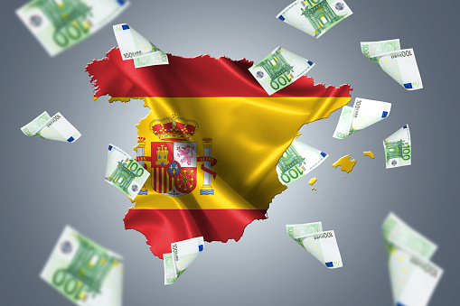 Wavy flag, Spanish map with European cash euro banknotes flying around, isolated on white background.