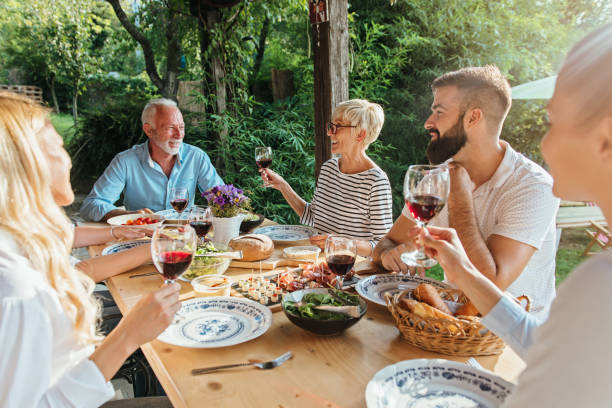 istock Family cheering over the dining table outdoors 1149568238