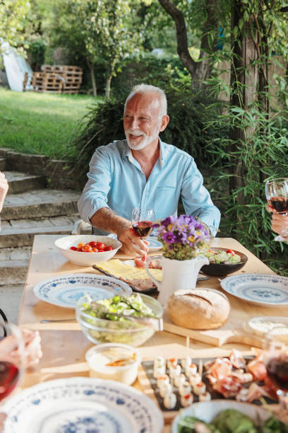 istock Family cheering over the dining table outdoors 1149568521