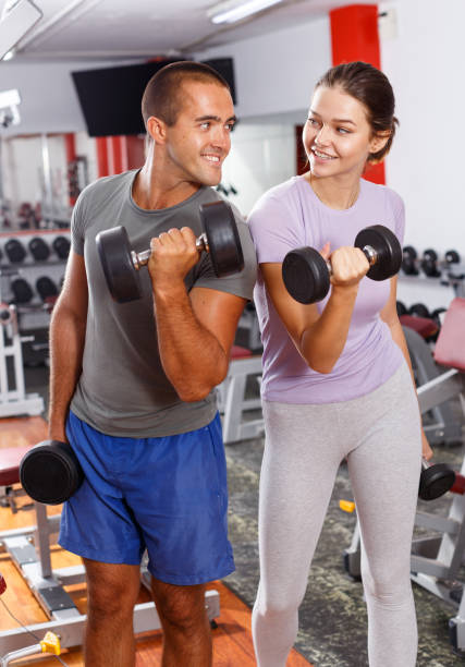 istock Man and woman posing with dumbbells 1149569570